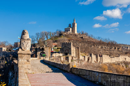 Tsarevets Fortress on a hill with a cloudy sky in the background